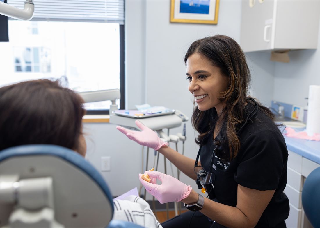 Kirti Chopra, DDS, FAGD in conversation with a patient at Smile Design Studio by KC