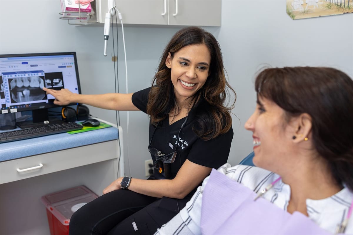 Kirti Chopra, DDS, FAGD reviewing x-rays on screen with a patient at Smile Design Studio by KC in Rittenhouse Square